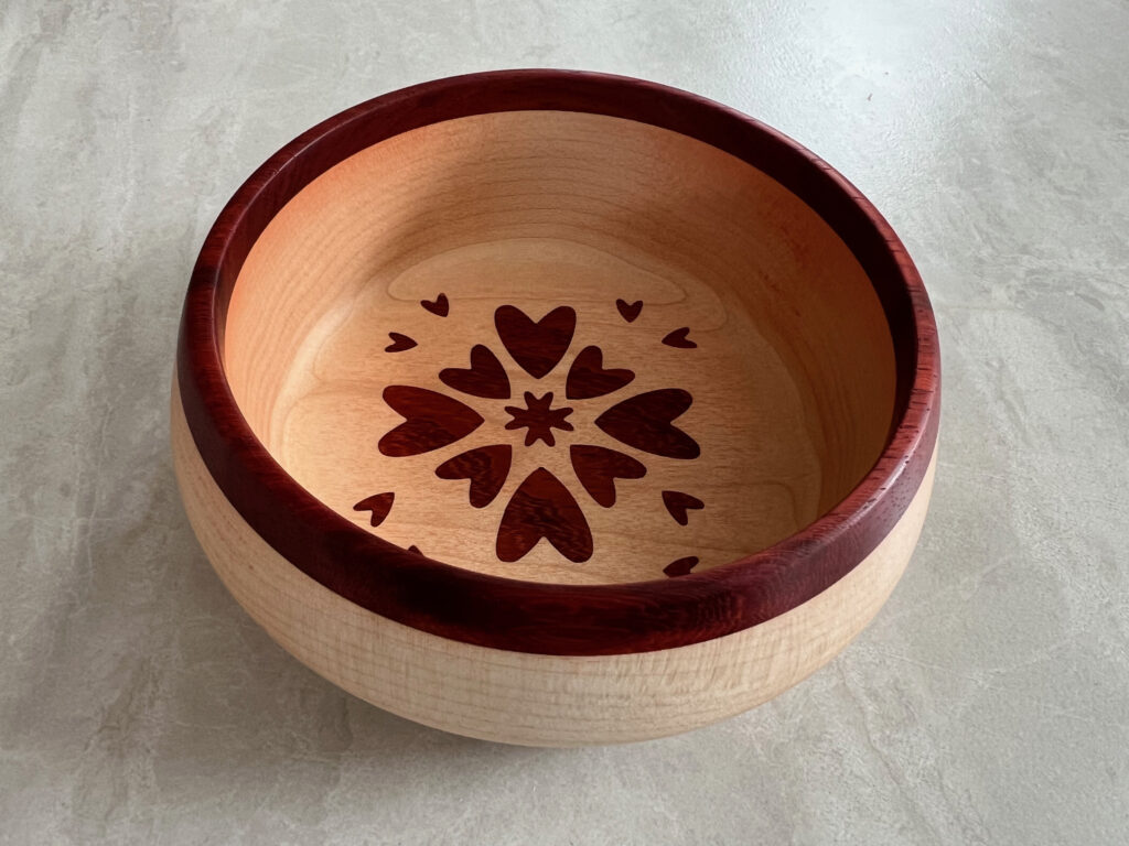 Turned bowl with heart inlay design